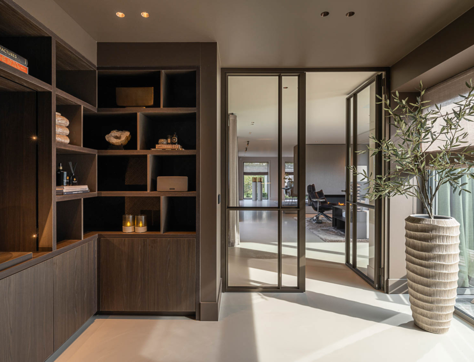 Dubbele stalen scharnierdeuren met veiligheidsglas in modern interieur met warme kleuren en luxe uitstraling.